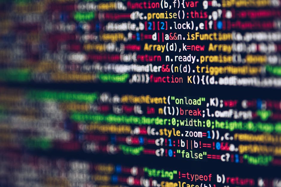 Close-up view of a computer screen displaying a snippet of HTML code with white text on a black background, slightly blurred with a radial motion effect. The scene features purple and blue lighting th